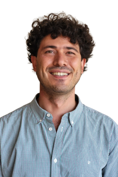 Amr Sabbah smiles at the camera. He has dark wavy hair and wears a maroon sweater